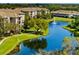 Community aerial view featuring pond with fountain and beautiful landscaping at 8300 Portofino Dr # 403, Davenport, FL 33896