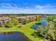 Community aerial view featuring pond with fountain and beautiful landscaping at 8300 Portofino Dr # 403, Davenport, FL 33896