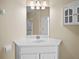 Bathroom vanity featuring white cabinets, a sink, and a large mirror at 8300 Portofino Dr # 403, Davenport, FL 33896