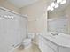 Bathroom features white vanity, toilet, and a glass-enclosed shower at 8300 Portofino Dr # 403, Davenport, FL 33896