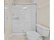 Bathroom featuring a pristine glass-enclosed shower and toilet at 8300 Portofino Dr # 403, Davenport, FL 33896