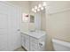 Bathroom featuring a white vanity, mirror, toilet, and bright lighting at 8300 Portofino Dr # 403, Davenport, FL 33896