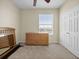 Cozy bedroom featuring neutral walls, carpet, a large closet, and a wooden dresser at 8300 Portofino Dr # 403, Davenport, FL 33896