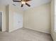 Bedroom featuring a ceiling fan, double door closet, and neutral carpeting at 8300 Portofino Dr # 403, Davenport, FL 33896