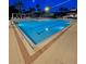 Large community pool, with clear blue water, lit up at night for an evening swim at 8300 Portofino Dr # 403, Davenport, FL 33896