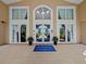 Exterior of entrance featuring glass doors, tile flooring, and a 'Bella Trae' welcome mat at 8300 Portofino Dr # 403, Davenport, FL 33896