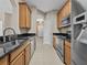 A bright kitchen with stainless appliances, granite countertops, and warm wood cabinetry at 8300 Portofino Dr # 403, Davenport, FL 33896