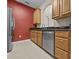 Kitchen featuring stainless steel dishwasher, granite countertops and wooden cabinetry at 8300 Portofino Dr # 403, Davenport, FL 33896