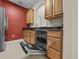 Bright kitchen showing stainless steel dishwasher and wooden cabinetry at 8300 Portofino Dr # 403, Davenport, FL 33896