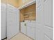 Laundry closet with white washer and dryer, as well as shelving for storage at 8300 Portofino Dr # 403, Davenport, FL 33896