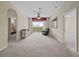 Bright living room featuring neutral carpet, ceiling fan, and sliding glass doors to the balcony at 8300 Portofino Dr # 403, Davenport, FL 33896