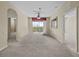 Bright living room featuring neutral carpet, ceiling fan, and sliding glass doors to the balcony at 8300 Portofino Dr # 403, Davenport, FL 33896
