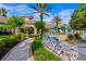 Community pool with lounge chairs, sun umbrellas, manicured landscaping, palm trees, and clubhouse at 8300 Portofino Dr # 403, Davenport, FL 33896