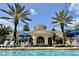 Community pool and clubhouse with lounge seating and tables, ideal for relaxing and entertaining at 8300 Portofino Dr # 403, Davenport, FL 33896
