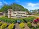 Community entrance sign amidst manicured greenery, showcasing the Bella Trae at Champions Gate at 8300 Portofino Dr # 403, Davenport, FL 33896
