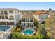 Aerial view of a luxury home showcasing the pool, spa, and manicured landscaping at 861 Golden Bear Dr, Reunion, FL 34747