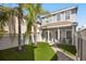 Inviting backyard with lush artificial turf, landscaping and a paved walkway leading to the house at 861 Golden Bear Dr, Reunion, FL 34747
