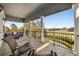 Outdoor seating on balcony offers a scenic view of landscaping and distant golf course at 861 Golden Bear Dr, Reunion, FL 34747