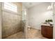 Well-lit bathroom with a glass-enclosed shower, granite countertop vanity, and tile flooring at 861 Golden Bear Dr, Reunion, FL 34747