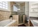 Bright bathroom with a glass enclosed shower, soaking tub and vanity at 861 Golden Bear Dr, Reunion, FL 34747