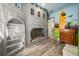 Unique bedroom with castle-themed bunk bed, colorful murals, and hardwood flooring at 861 Golden Bear Dr, Reunion, FL 34747