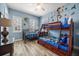 Spacious bedroom with a ceiling fan, wood laminate flooring, and multiple windows for natural light at 861 Golden Bear Dr, Reunion, FL 34747