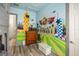 Whimsical bedroom featuring a Harry Potter themed mural, dresser and decor at 861 Golden Bear Dr, Reunion, FL 34747