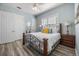 Inviting primary bedroom featuring wood laminate flooring, bright walls, and ensuite bathroom at 861 Golden Bear Dr, Reunion, FL 34747