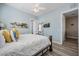 Relaxing primary bedroom with wood laminate flooring, ensuite bath, and bright walls at 861 Golden Bear Dr, Reunion, FL 34747