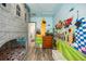 Fantasy-themed bedroom with castle bunkbed, vibrant murals, and wood floors creating an imaginative space at 861 Golden Bear Dr, Reunion, FL 34747