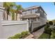 Attractive two-story home with gray exterior, walkway, gate and trimmed landscaping at 861 Golden Bear Dr, Reunion, FL 34747