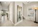 Inviting hallway with tile flooring, neutral paint, and stylish lighting fixtures leading to other living spaces at 861 Golden Bear Dr, Reunion, FL 34747