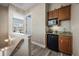 Upstairs hallway with a convenient wet bar featuring granite countertops and a mini fridge at 861 Golden Bear Dr, Reunion, FL 34747