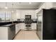 Modern kitchen featuring stainless steel appliances, granite countertops, and white cabinets at 861 Golden Bear Dr, Reunion, FL 34747