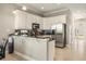 Bright kitchen with white cabinetry, stainless steel appliances, and a breakfast bar at 861 Golden Bear Dr, Reunion, FL 34747