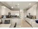 Spacious kitchen with white cabinets, black countertops, stainless steel appliances, and an open layout at 861 Golden Bear Dr, Reunion, FL 34747