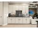 Elegant kitchen features sleek white cabinetry, dark countertops, and a stylish backsplash design at 861 Golden Bear Dr, Reunion, FL 34747