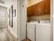 Well-lit laundry room with a washer, dryer, and built-in cabinets at 861 Golden Bear Dr, Reunion, FL 34747