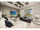 Stylish living room with coffered ceiling, contemporary furniture, and a sliding glass door view to the pool at 861 Golden Bear Dr, Reunion, FL 34747