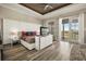 Main bedroom featuring a tray ceiling, wood floors and a private balcony at 861 Golden Bear Dr, Reunion, FL 34747