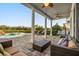 Covered patio with seating area, pool, and lush landscaping perfect for entertaining or relaxing at 861 Golden Bear Dr, Reunion, FL 34747
