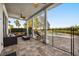 View of covered patio with seating, ceiling fan and access to backyard at 861 Golden Bear Dr, Reunion, FL 34747
