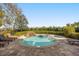 Private backyard oasis with a stunning pool, spa, and serene waterfall feature at 861 Golden Bear Dr, Reunion, FL 34747