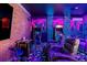 A bright arcade and theater room featuring a cityscape mural and brick accents, perfect for entertaining at 861 Golden Bear Dr, Reunion, FL 34747
