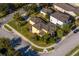 Aerial view of a yellow house with mature trees, and a well-maintained lawn, in a desirable neighborhood at 1000 Seburn Rd, Apopka, FL 32703