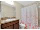 Cozy bathroom featuring a floral shower curtain and neutral-toned walls at 1000 Seburn Rd, Apopka, FL 32703