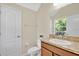Cozy bathroom features a cream colored wall, granite countertop, and bright lighting at 1000 Seburn Rd, Apopka, FL 32703