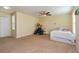 Spacious bedroom with carpet flooring, ceiling fan, and a cozy play area for a  at 1000 Seburn Rd, Apopka, FL 32703