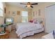 Comfortable bedroom with a ceiling fan, a double bed with colorful pillows, and carpeted flooring at 1000 Seburn Rd, Apopka, FL 32703