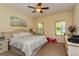 Cozy bedroom with a ceiling fan, natural light from two windows, and light-colored furnishings at 1000 Seburn Rd, Apopka, FL 32703